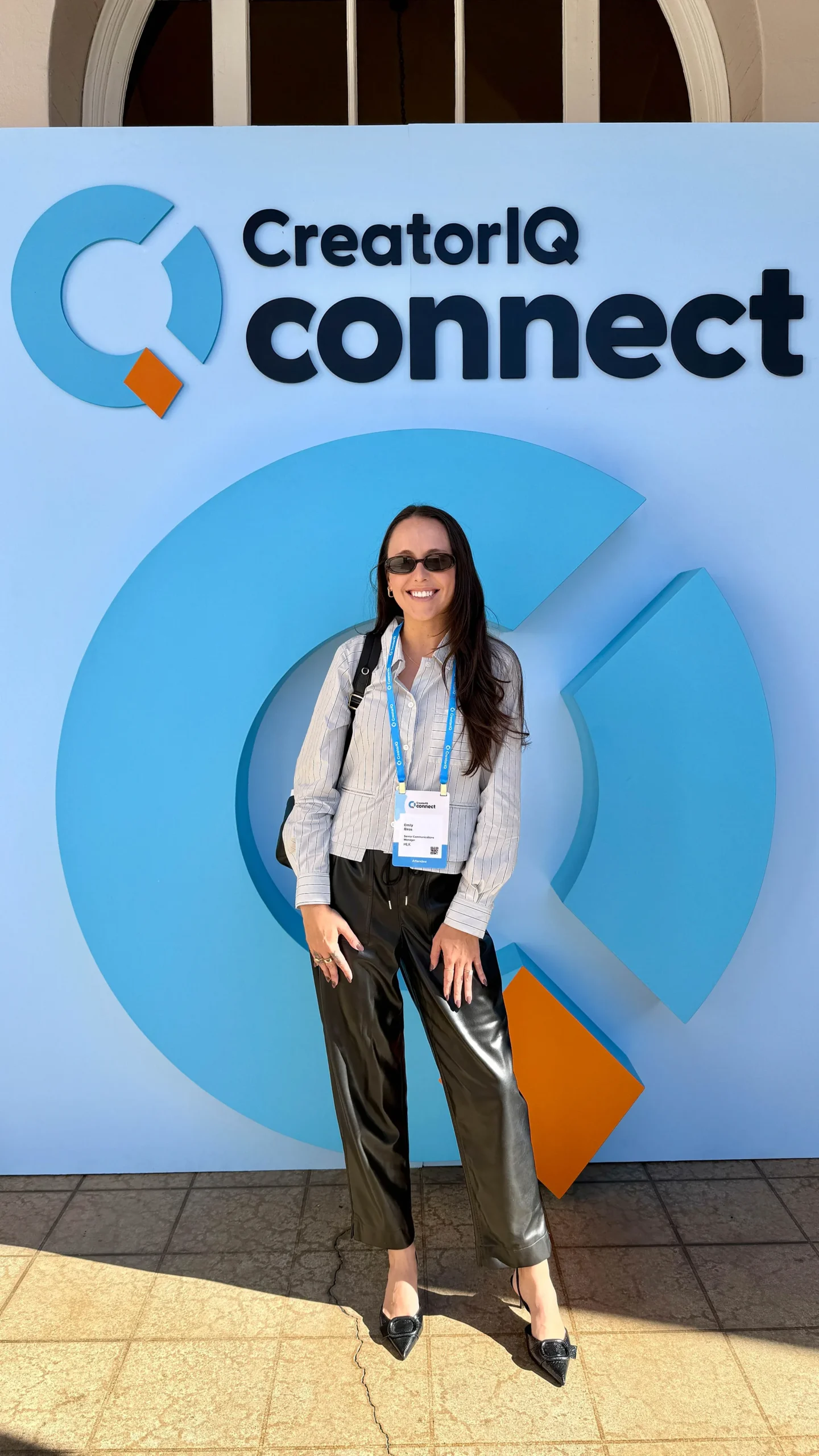 Emily Biras in front of the CreatorIQ connect sign.