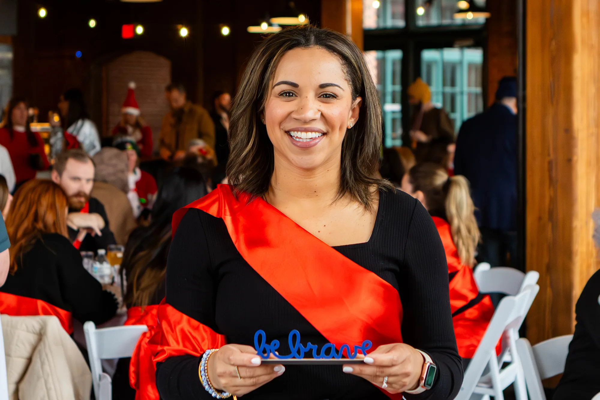 Rachel Weis holding the "Be Brave" award.