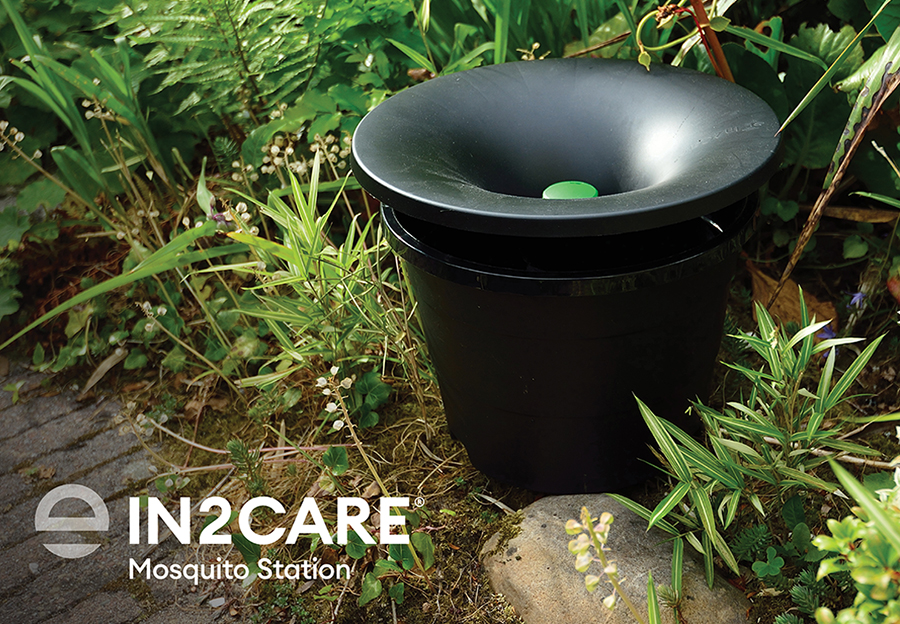 The Envu In2Care mosquito station product in the ground with surrounding greenery.
