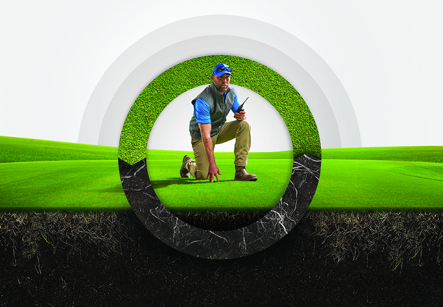 A man in workwear holding a walkie-talkie kneels on a golf green, framed inside a large circular graphic showing a cross-section of turf and roots against a rolling green landscape.